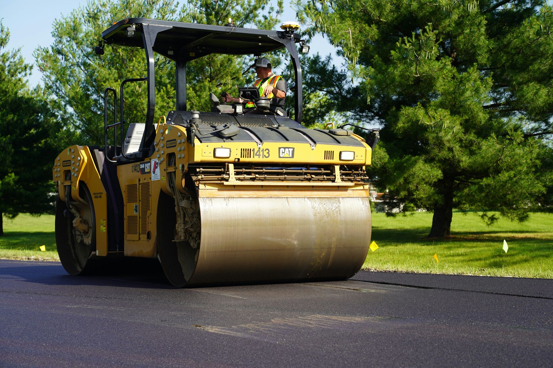 Asphalt roller compacting a freshly paved road