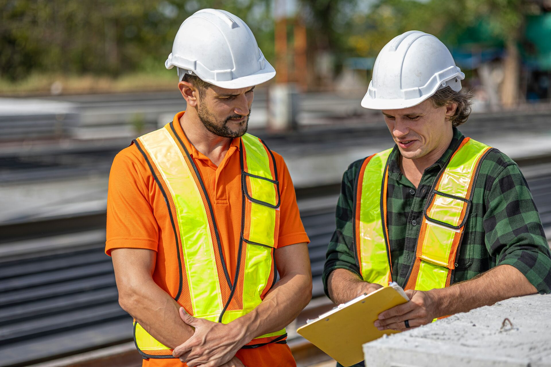 Ace Builders crew members reviewing site plans on a job site