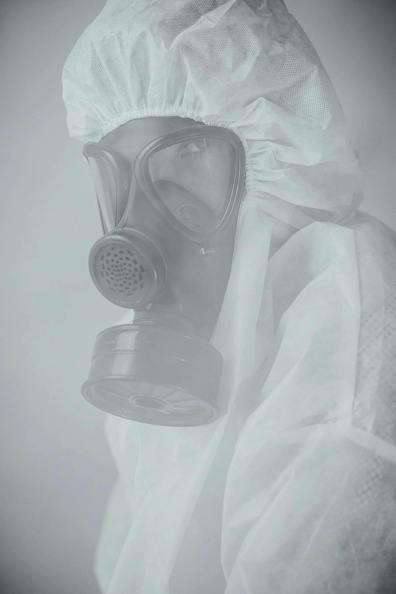 Ace Builders crew member in full PPE and respirator performing hazardous material abatement
