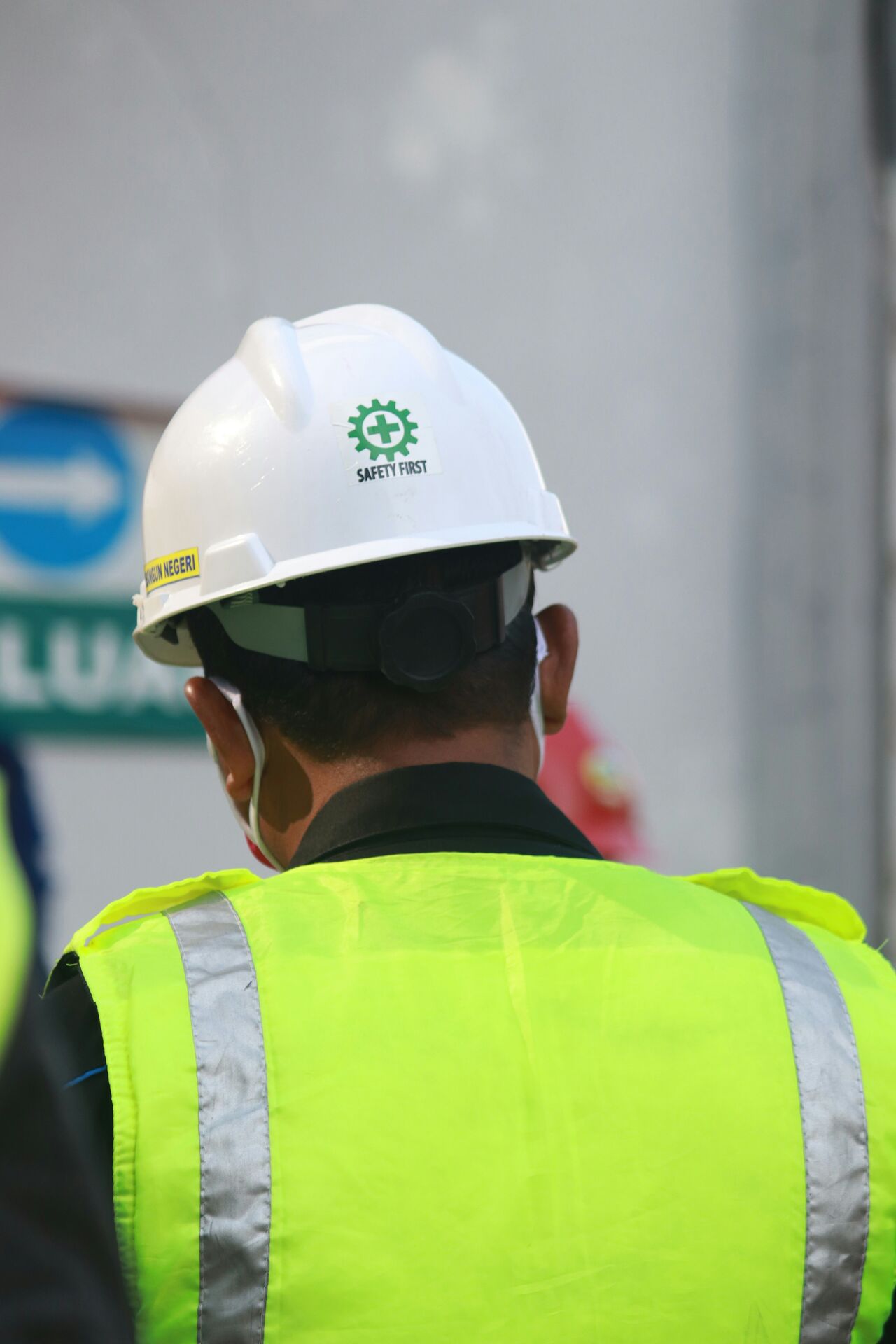 Crew member wearing a Safety First hard hat and hi-vis vest on site